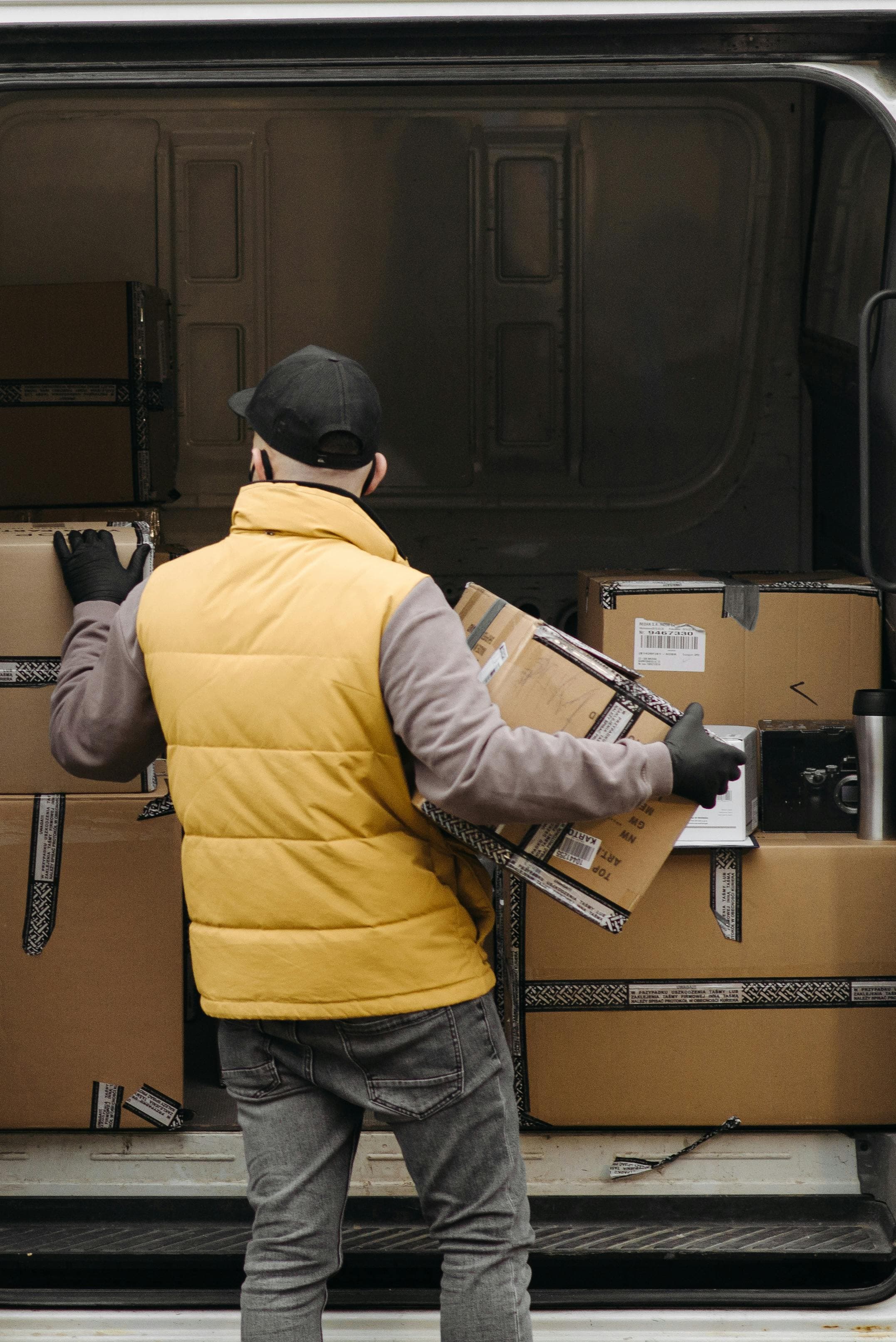 Worker carrying a box in a warehouse